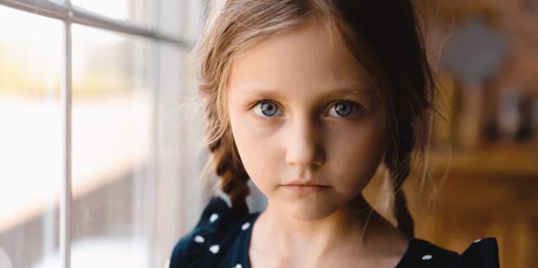 how to help a kid being ostracized grade-school age girl in braids looks solemnly at camera