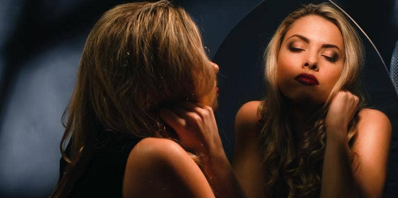 woman looking at self in mirror