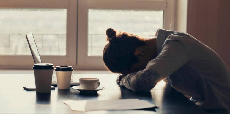 When You Can’t Escape The Overwhelming Sadness & Exhaustion woman with hands crossed and head bowed