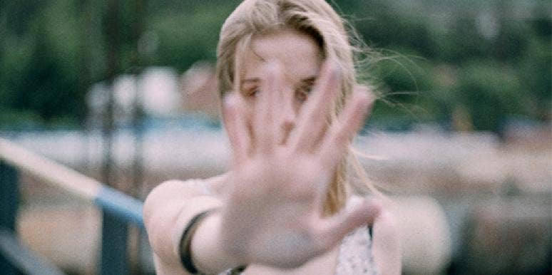 How Your Hand Shape Reveals Your Greatest Personal Strengths And Weaknesses woman holding her hand palm in front of her face