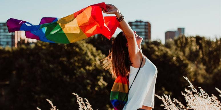 The Day My Daughter Came Out As Pansexual woman holding up a gay pride flag