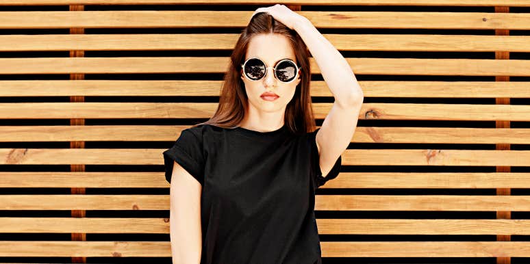 telltale signs you're in parasitic relationship serious woman standing against slatted wall