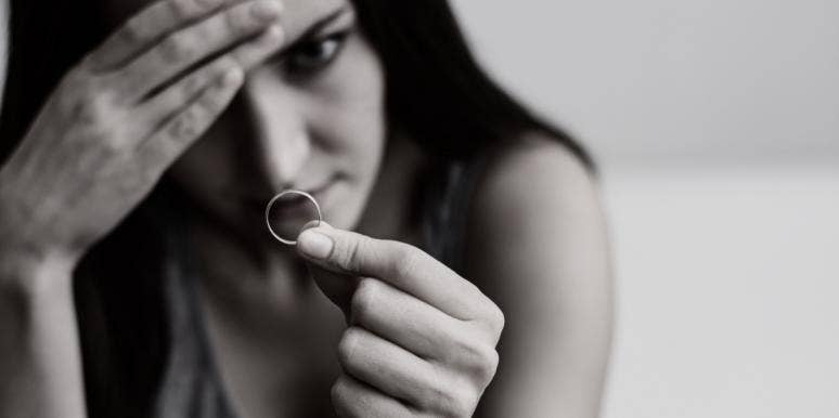 My Parents Forced Me To Stay Married To My Horribly Abusive Husband woman looking at engagement ring in black and white