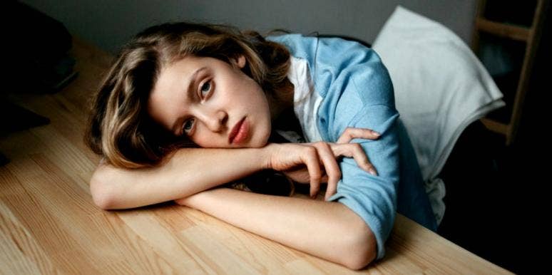 Signs Of Past Life Traumatic Stress Disorder & How To Heal Trauma sad woman on a desk