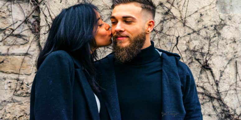 What PDA Means In (And About) Your Relationship woman kissing man on the cheek