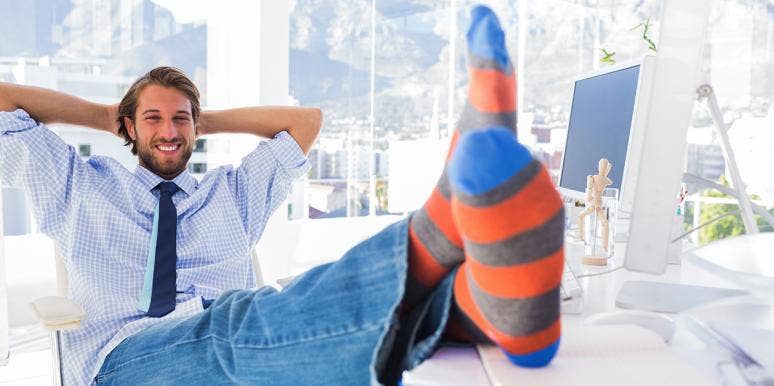 Why People Who Wear Crazy Socks Are Smart, Successful, And Revolutionary man sitting at desk with feet up