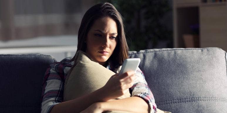 personal attacks on social media woman looking at her smartphone