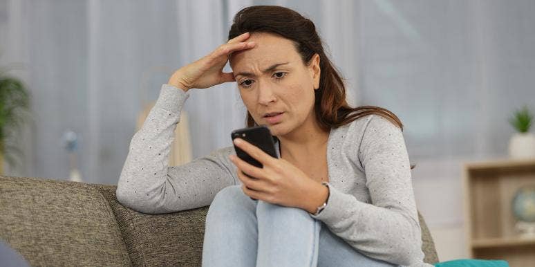 I'm A Married Woman Who Tried Tinder And Whoa, What A Hot Mess woman looking exasperated on phone