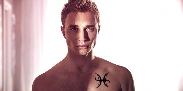man with pisces tattoo on chest