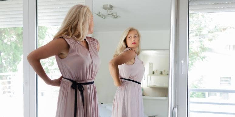 poor body image woman looking in the mirror