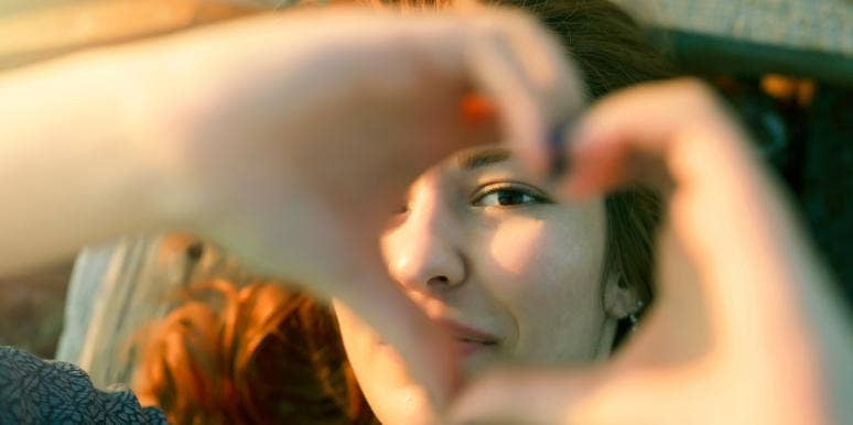 positive mindset woman forming a heart
