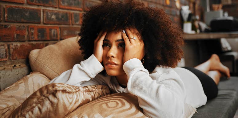 Sad Signs You’re Suffering From Post-Relationship Stress Disorder hopeless woman on couch