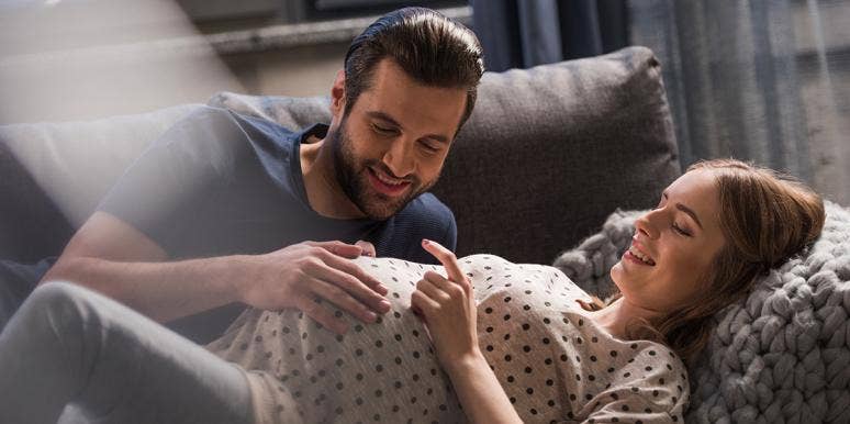 Getting Sober Saved My Marriage — And Finally Got Me Pregnant man looking at pregnant wife belly
