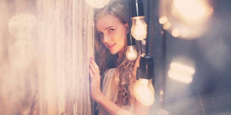woman surrounded by lightbulbs