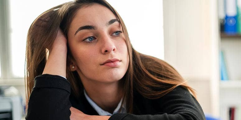 A 2-Step Psychological Trick To Stop Procrastinating Woman leaning her head against her hand