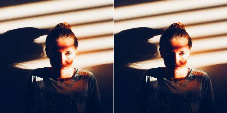 8 Common Symptoms Of PTSD That Can Affect Anyone mirror image of woman in ponytail window blinds shades