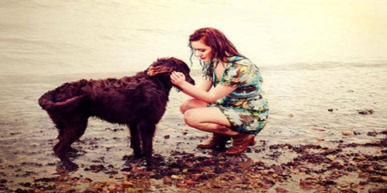 woman and dog by lake woman and dog by lake