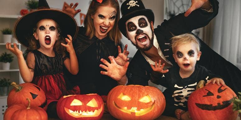 family in halloween costumes with pumpkins family in halloween costumes with pumpkins