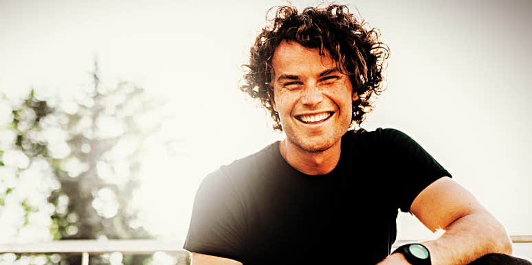 smiling man with curly hair and freckles