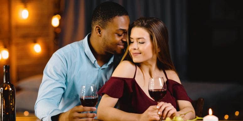 When Do Racial Dating Preferences Become Racist? interracial couple snuggles during a romantic date