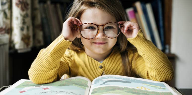 little girl reading book