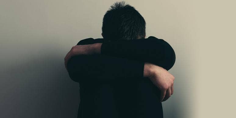 What It's Really Like To Be A Male Victim Of Rape man with head on knees