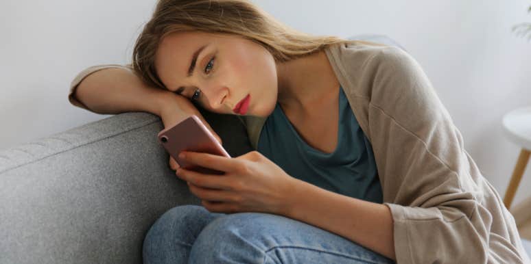 Why Keeping His Old Texts Is Nothing But A Waste Of Time somber woman reading old texts