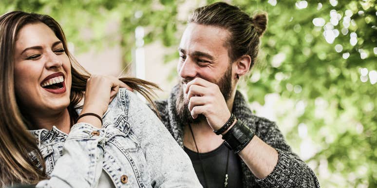 Unsexy Hints You're Primed To Find Love woman and man laughing with each other