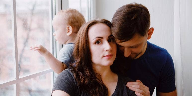 real love and being honest in a relationship couple by a window with baby