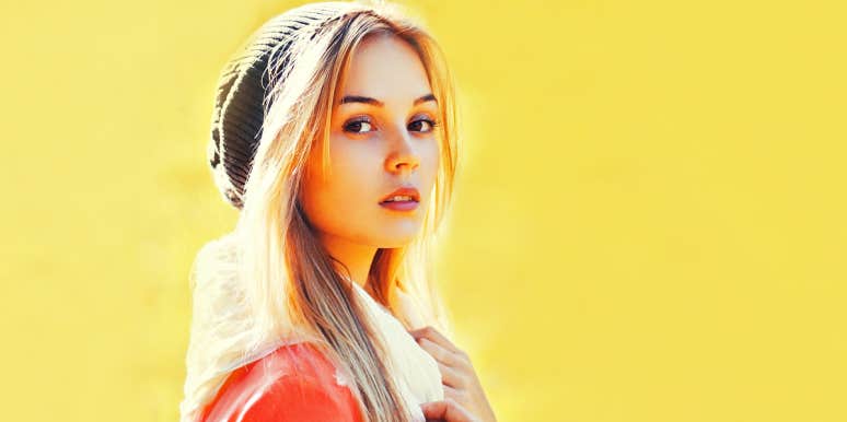 Trying to be feminine makes us miserable Young blonde woman against yellow wall