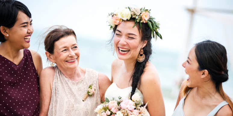 cheerful bride with family on the beach