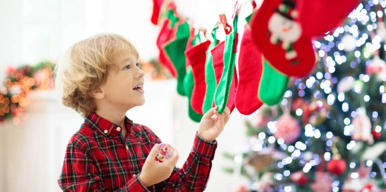 little boy hanging up christmas stocking