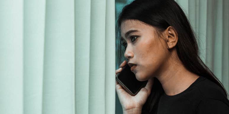 Woman Wonders If She Is Wrong For Filing Noise Complaint Against Neighbor With Newborn Baby woman on phone looking out window