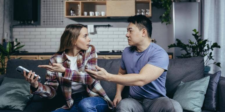 Woman Wonders If She Is Wrong After Freaking Out Over The Photo Her Husband Used As Her Contact Photo On His Phone married couple arguing on the couch over the phone