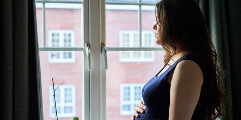 worried woman wondering how to tell her husband she's pregnant