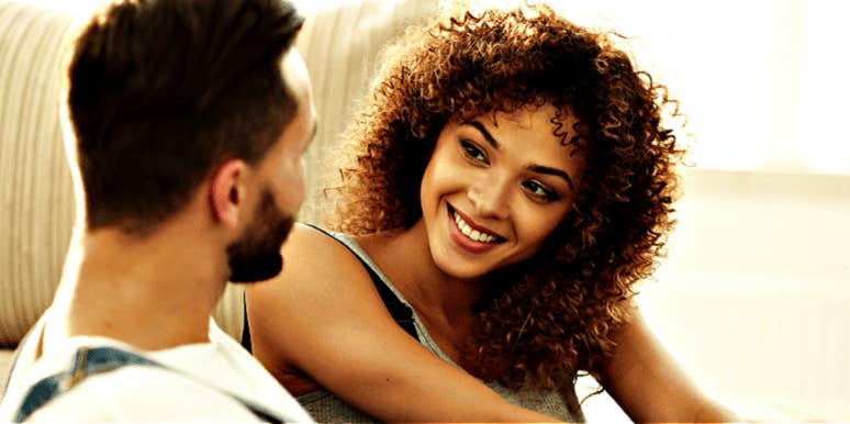 The Hidden Reason Exciting Relationships Fall Apart & How To Fix It woman with natural curly hair smiles at a man