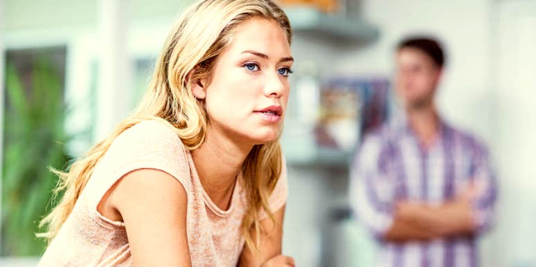 Pensive woman thinking with partner in background