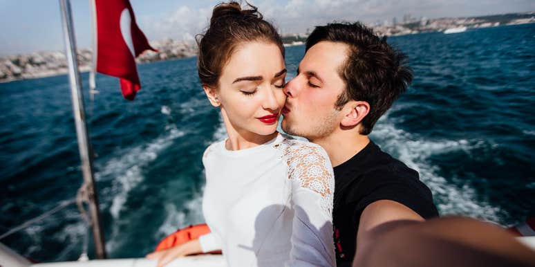 man kissing woman on boat