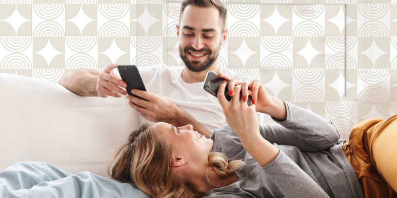 Couple on the couch laughing on their phones