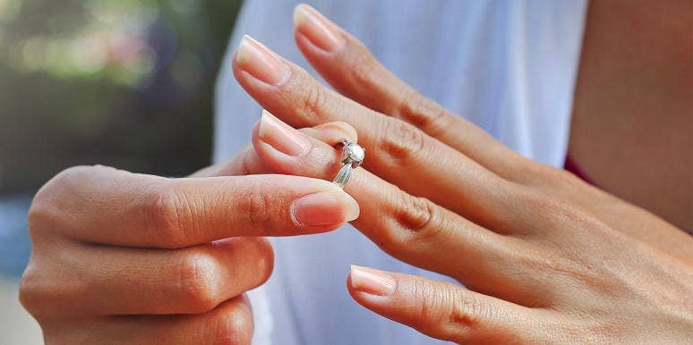 I Stopped Wearing My Wedding Ring And Had A Marriage Epiphany woman putting engagement ring on hand