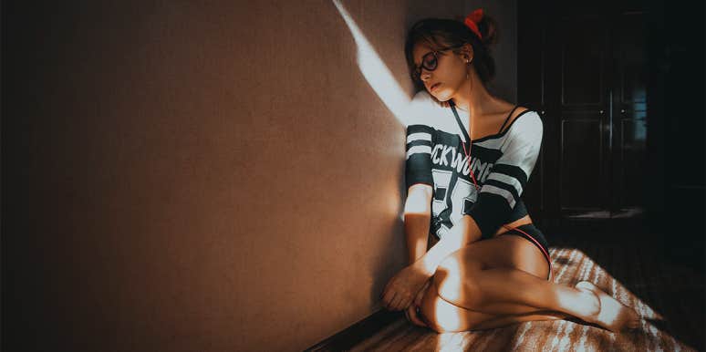 11 Signs Your Root Chakra Is Blocked & How To Unblock It woman sitting on the floor