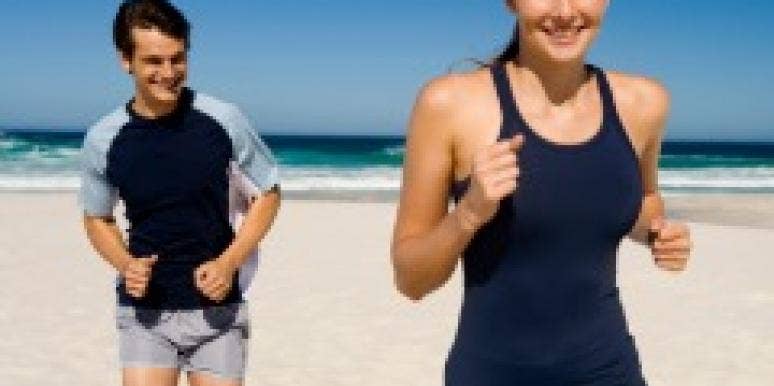 man and woman running on beach