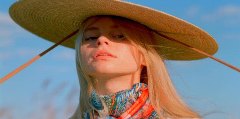 The Pros And Cons Of Falling In Love With A Sagittarius woman with hat in sunlight