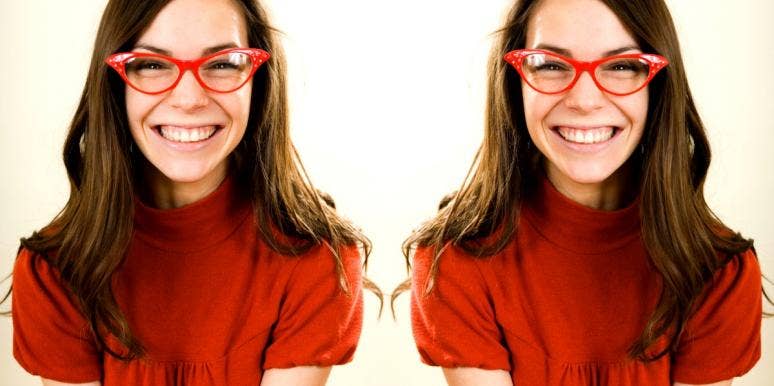 woman with red glasses smiling