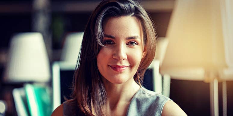 Mental Health Experts Reveal Their #1 Time-Saving Habit (To Gain Hours Each Week) woman in library, smiling serenely
