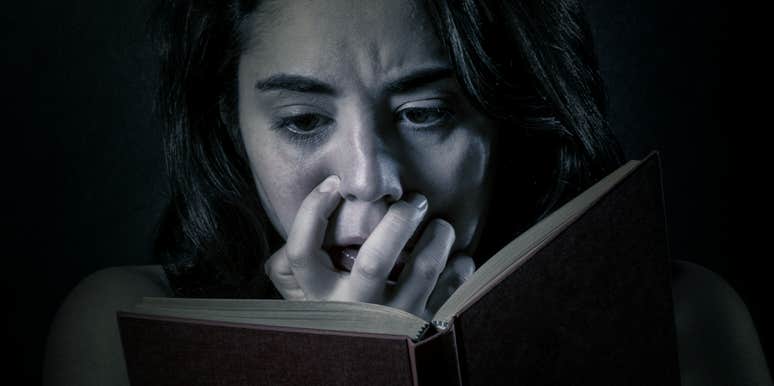 25 Scariest Books Of All Time That Will Freak You Out scared woman reading a book