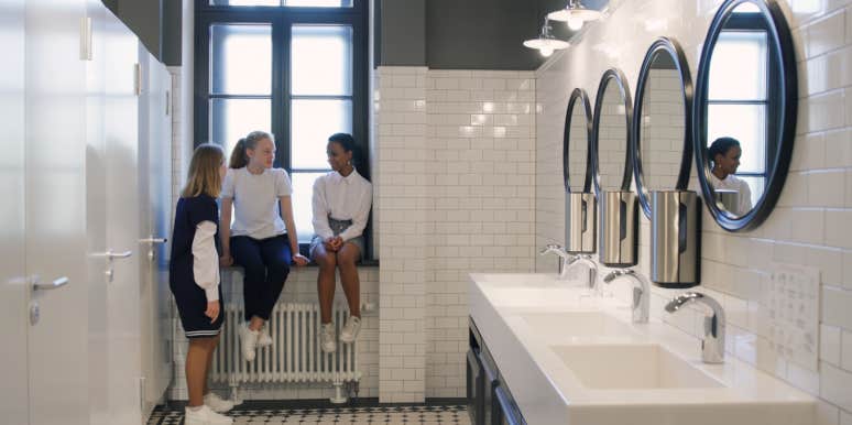 teen girls chat in school bathroom during break