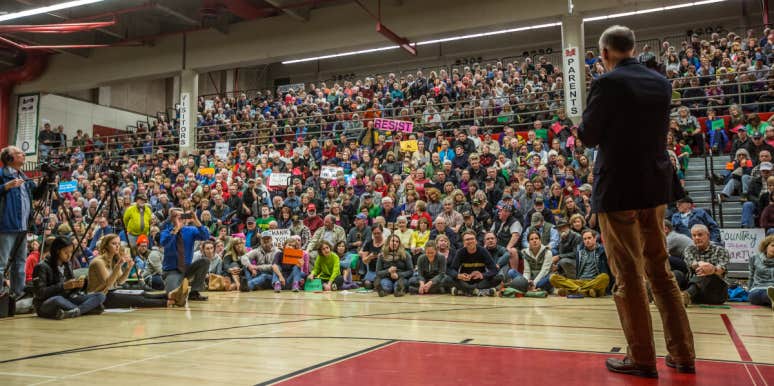 Why Are People Fighting To Remove Critical Race Theory From Schools? Congressman giving speech at town hall meeting