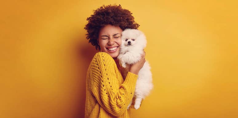 Here's Why You Treat Your Dog Like Your Child woman holding up her dog