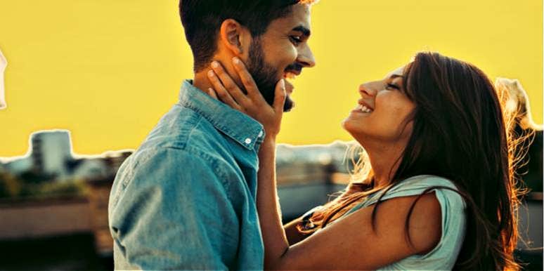 7 Secrets For Avoiding Emotional Distance With Your Partner young couple looking at each other in front of yellow sky, city scape